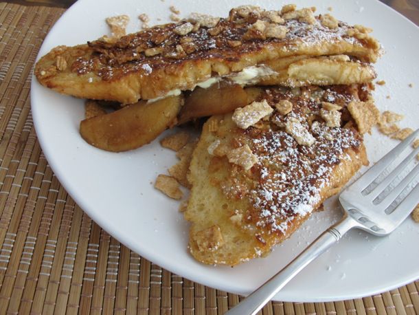 Closeup of Cinnamon Toast Crunch® Coated Apple Stuffed French Toast, served on a white plate.