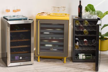 Three wine refrigerators, each styled differently, with glasses and bottles on top and inside.