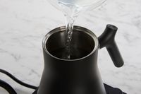 Person pouring water into Fellow Stagg EKG Electric Gooseneck Kettle