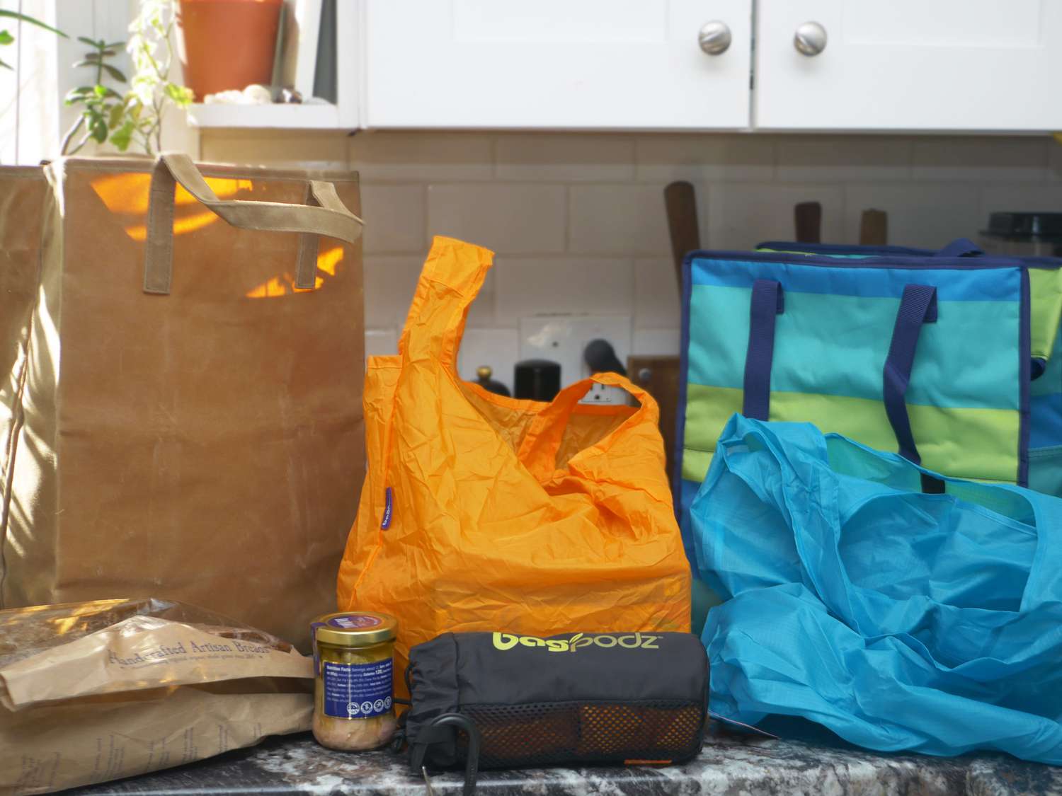 a bunch of grocery bags on a black marble countertop