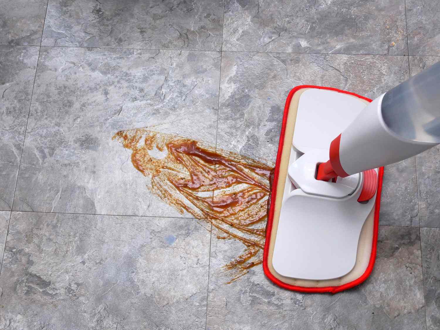 a spray mop wiping up barbecue sauce off the floor