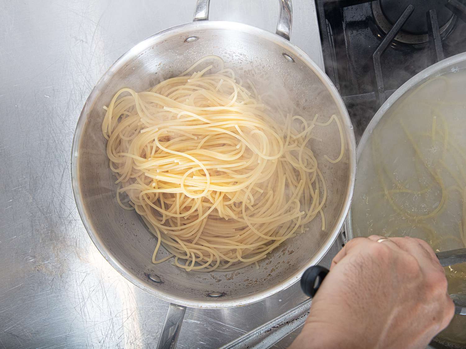 Overhead view of transferring pasta