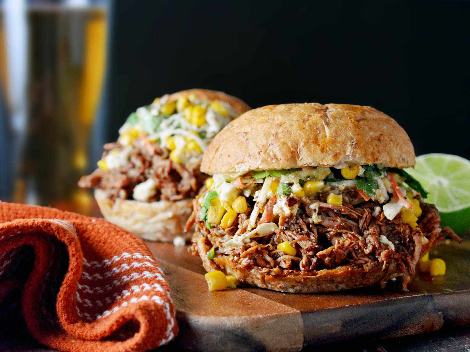 Chorizo-spiced pulled pork with Mexican street corn piled high on a bun.