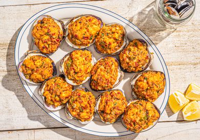 Overhead view of stuffies on a plate with lemon wedges and fork