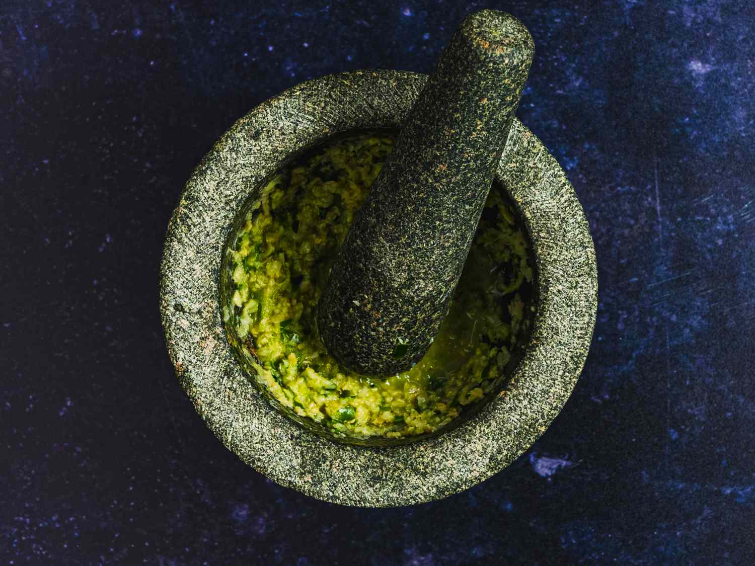 Garlic, ginger, chiles, 1 tablespoon of lemon juice, and Â½ teaspoon of kosher salt processed into a fine paste inside a mortar and pestle.