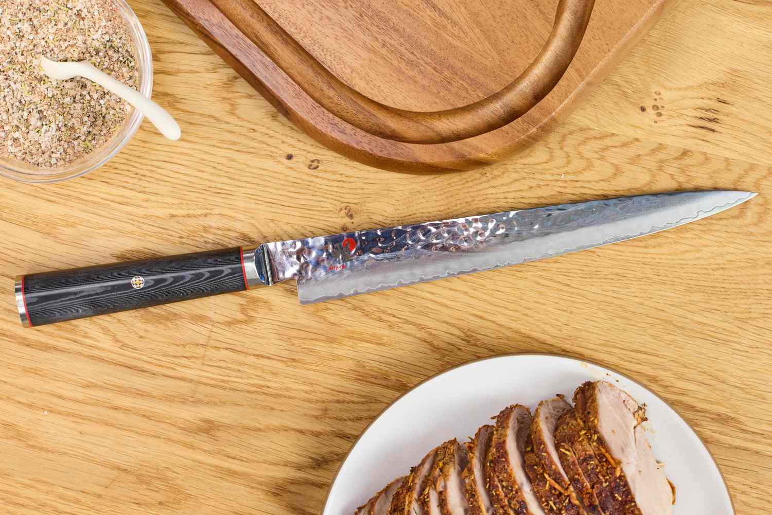 The Miyabi Mizu SG2 9.5 Inch Slicing Knife on a table