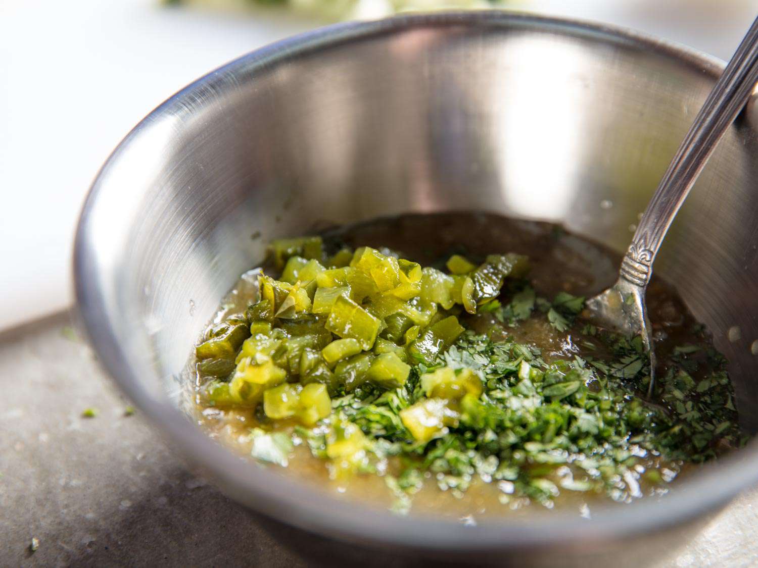 Diced roasted pepper and cilantro are added to a tomatillo salsa.