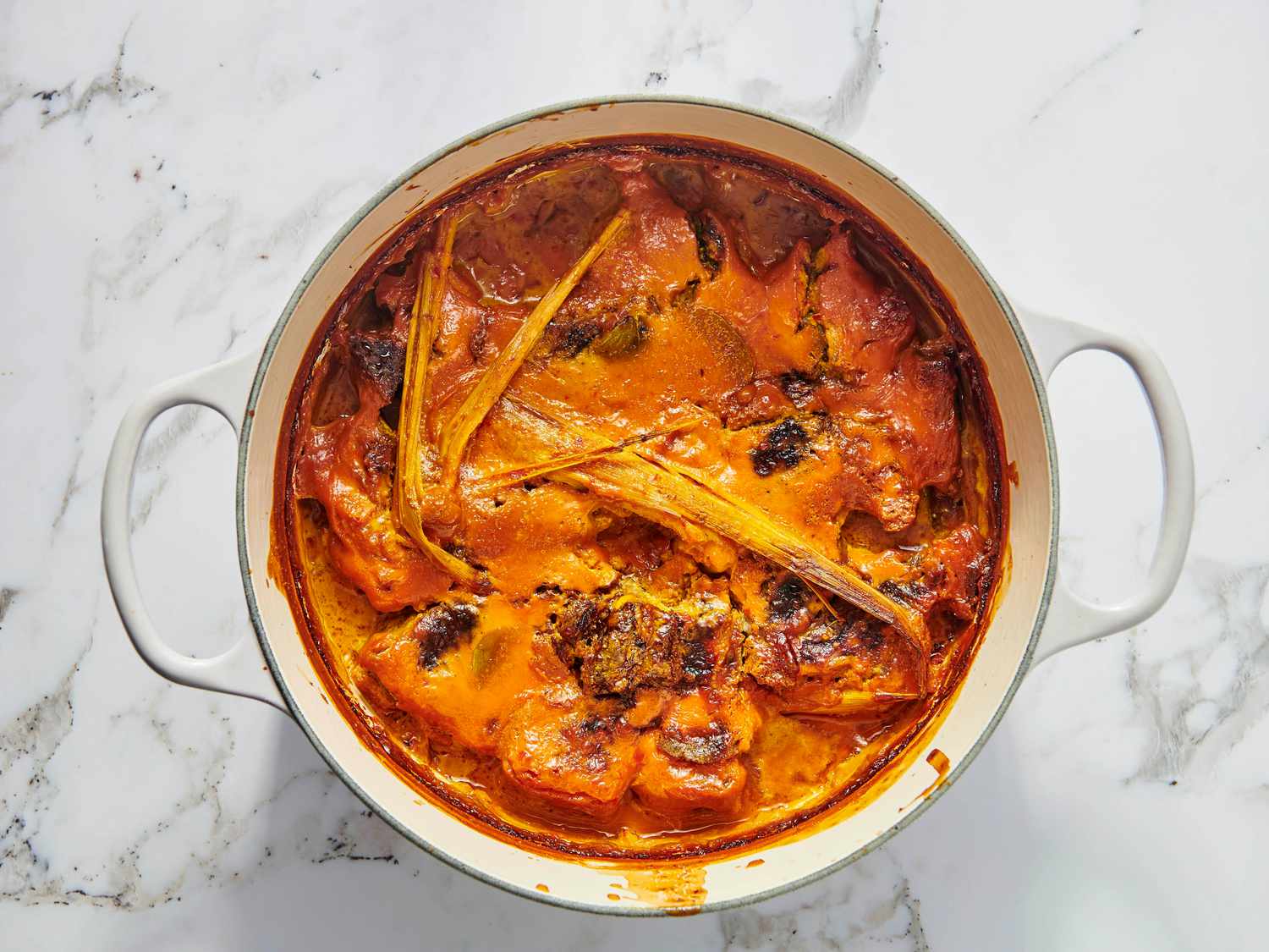 Randang cooking for about 2 hours, with reduced sauce in a dutch oven 