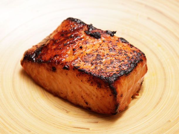 A miso glazed salmon resting on a wooden surface