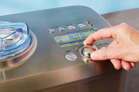 Hand adjusting control dial on Breville The Smart Scoop Ice Cream Maker