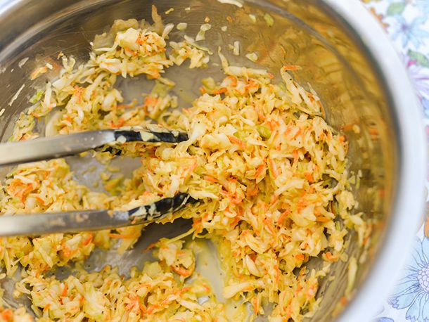 Tossing together dressing and veggies for mustardy coleslaw.