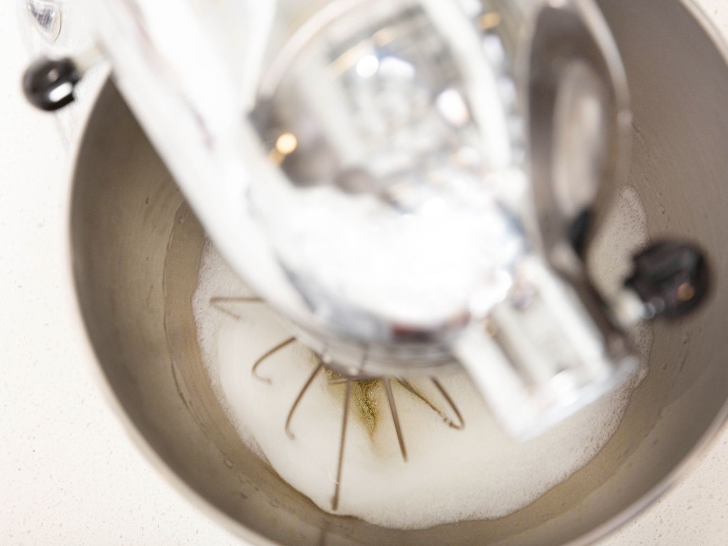 Overhead angle of stand mixer mixing egg whites 