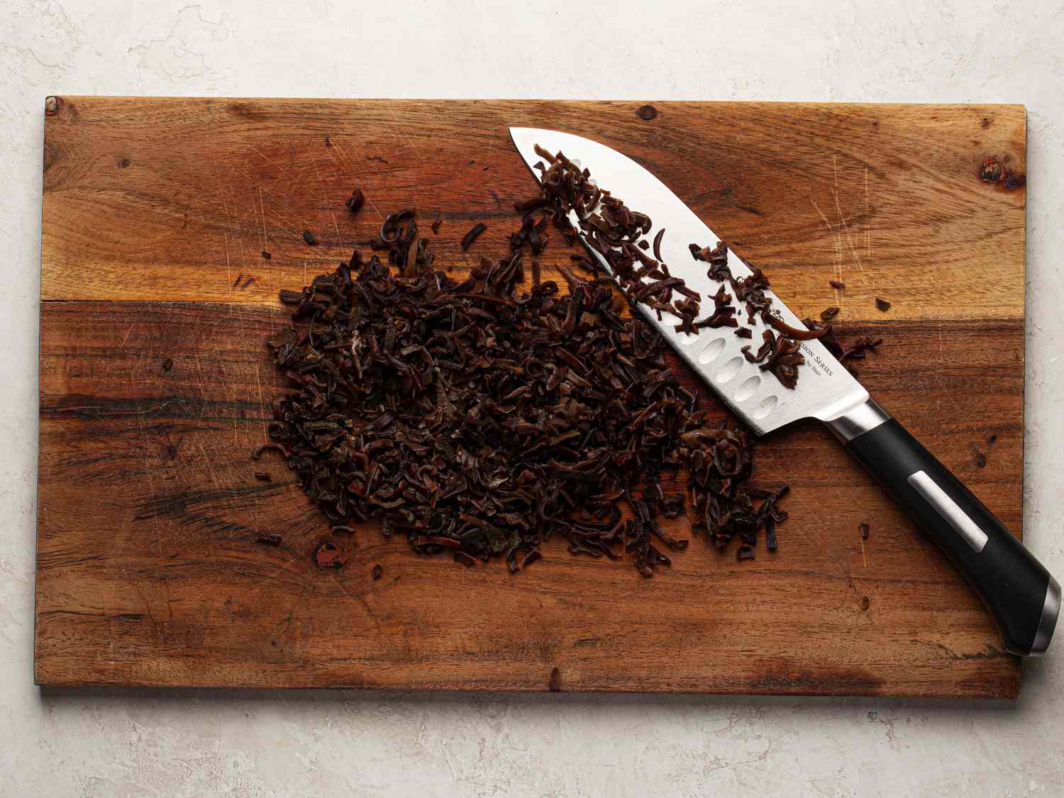 Overhead view of mushrooms roughly chopped on a cutting board
