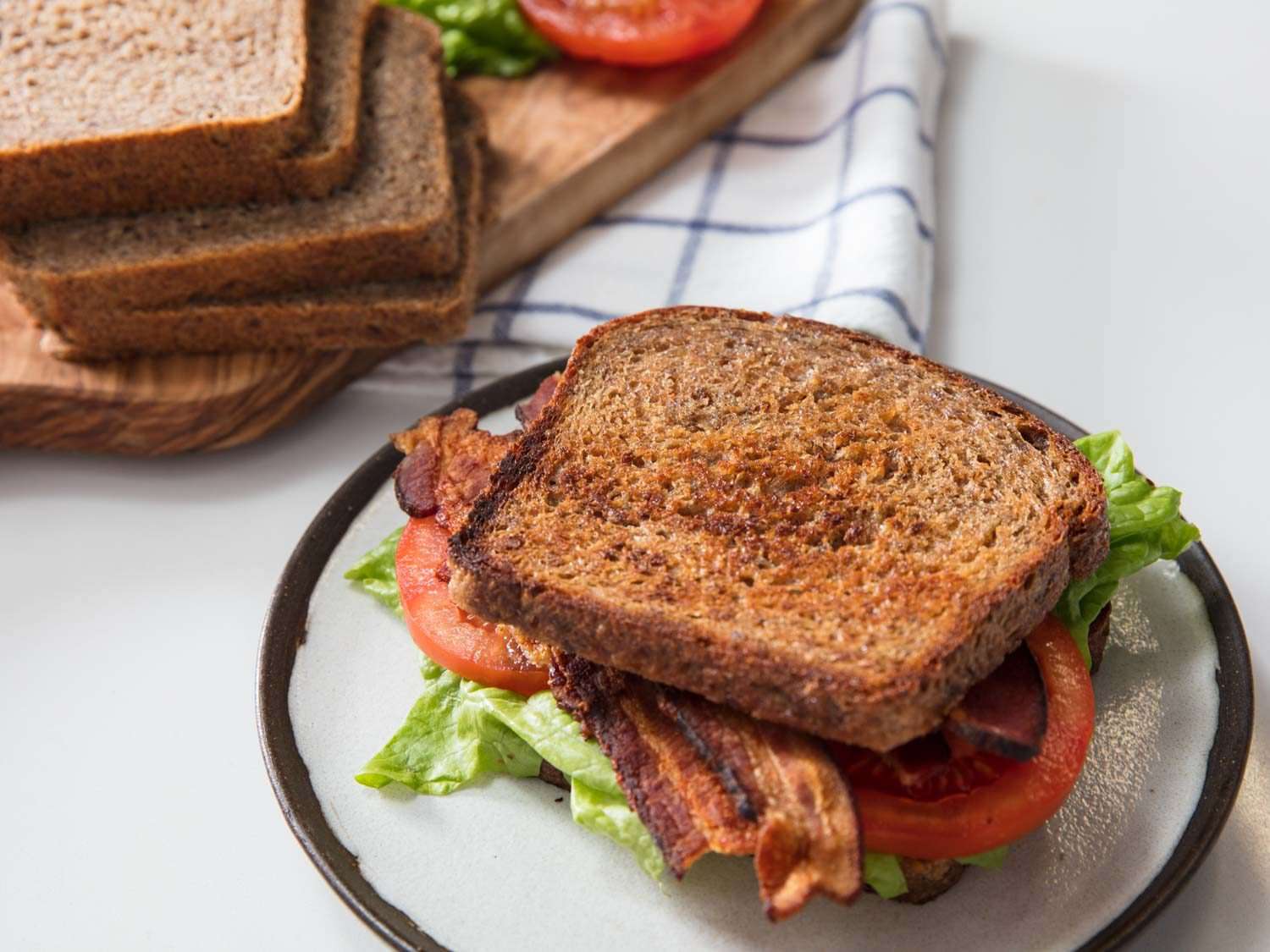A BLT sandwich made with whole wheat bread slices. 