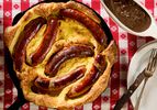 Toad in the Hole served in a skillet with a red checkered tablecloth