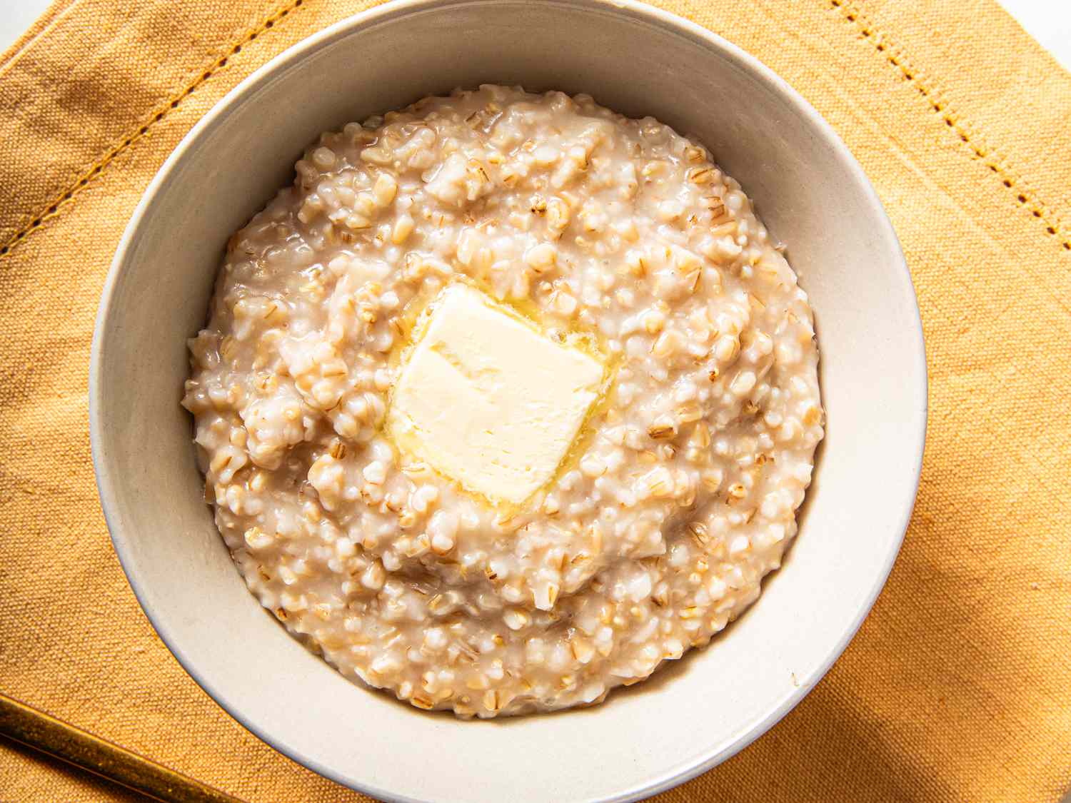Overhead view of rice cooker oatmeal topped with butter