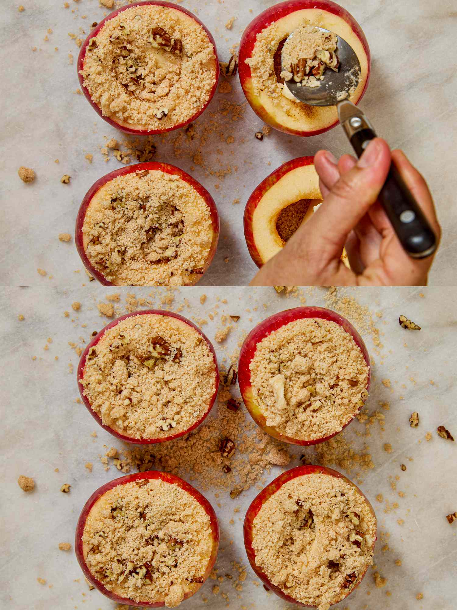 Hand filling halved and cored apples with crumbly topping a preparation step for baked apples
