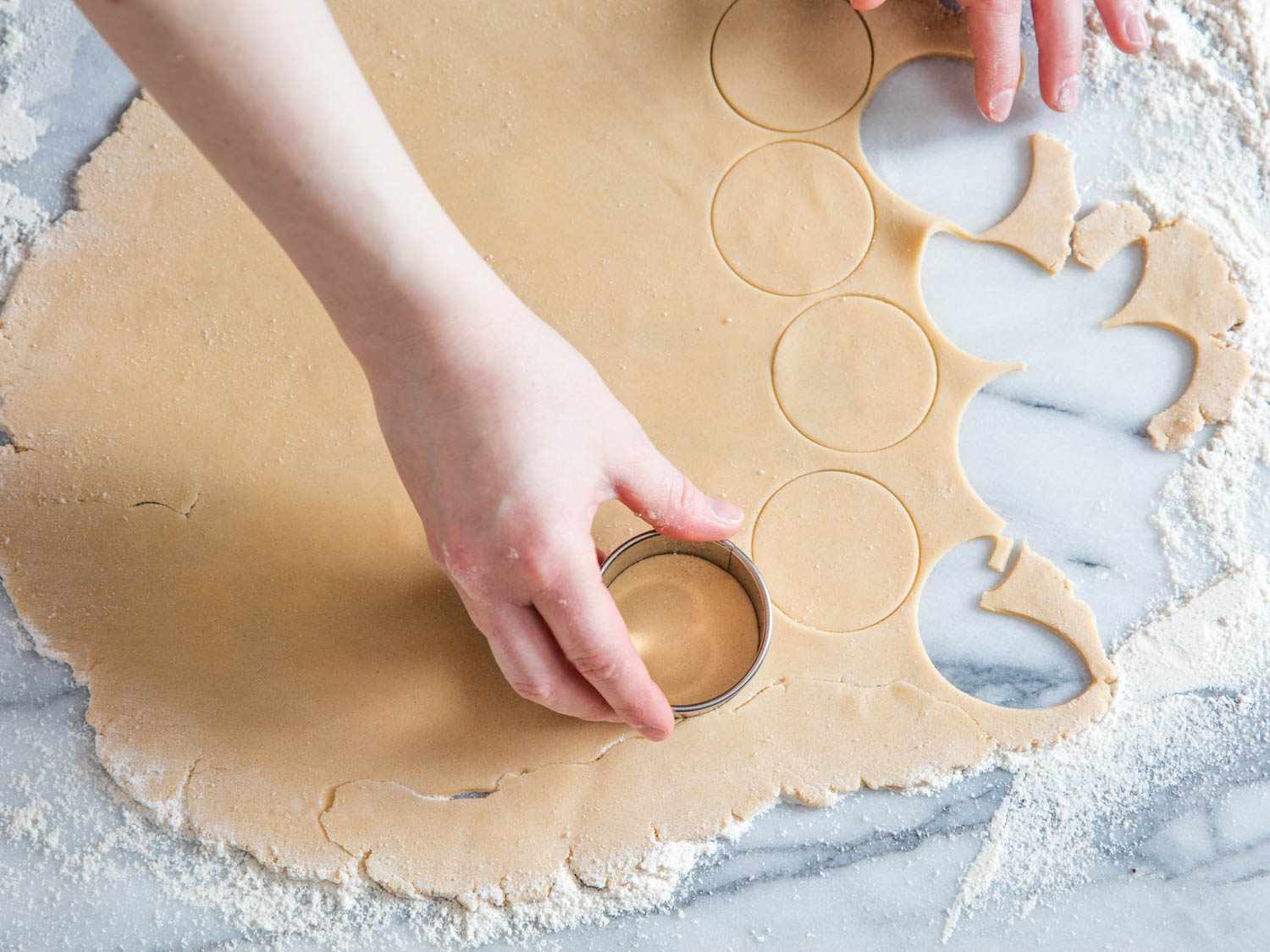Author uses a cookie cutter to punch out rounds of dough.
