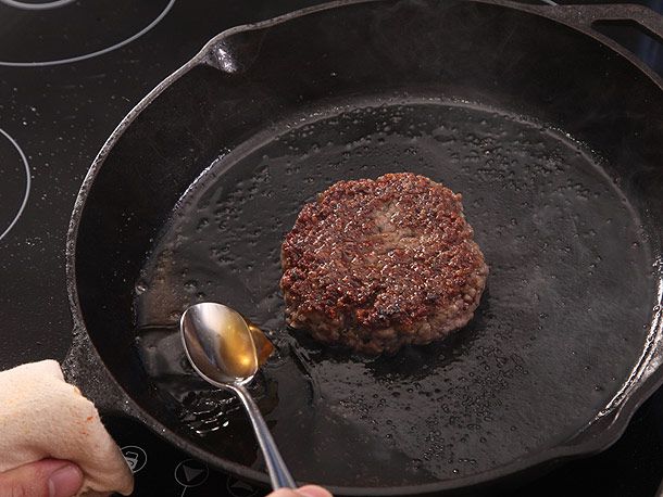 basting burger on cast iron skillet