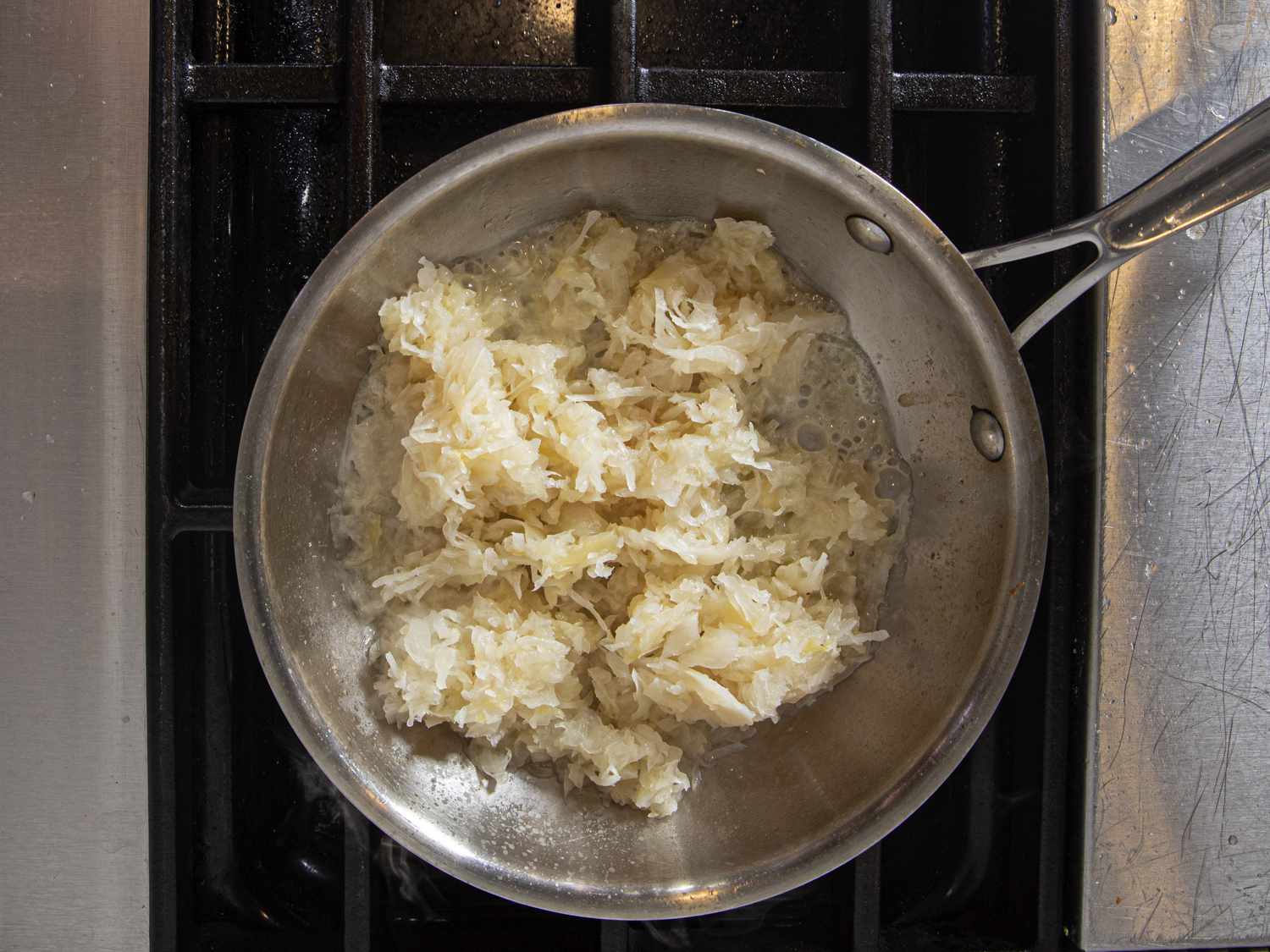 Overhead view of sauerkraut in a pan on the stove 