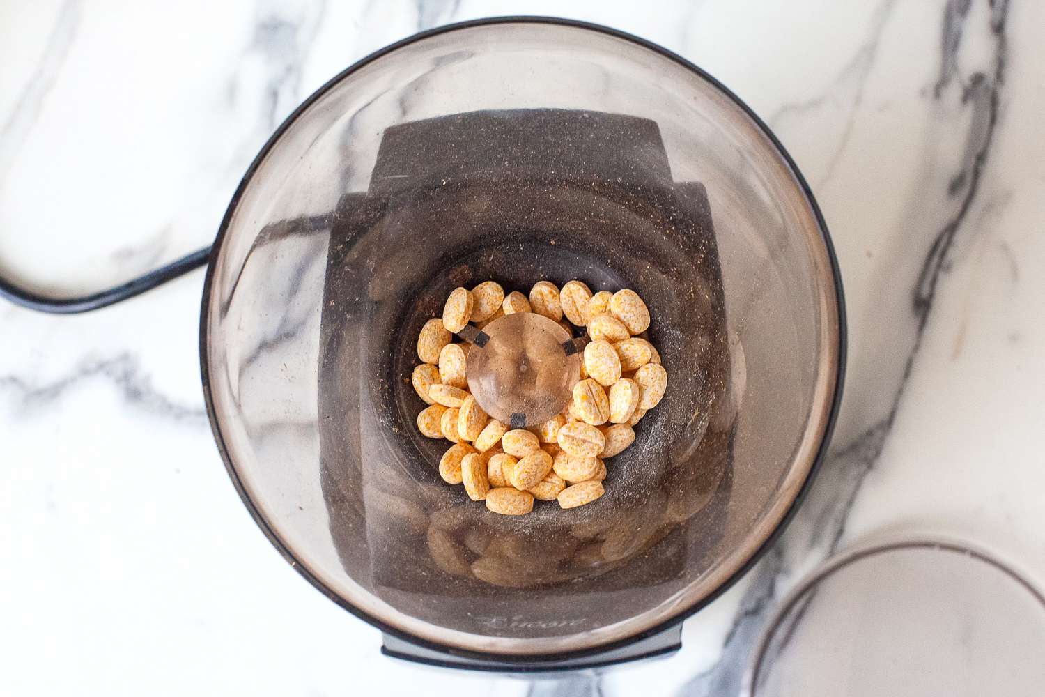 Coffee grinder cleaning tablets in the hopper of a coffee grinder.