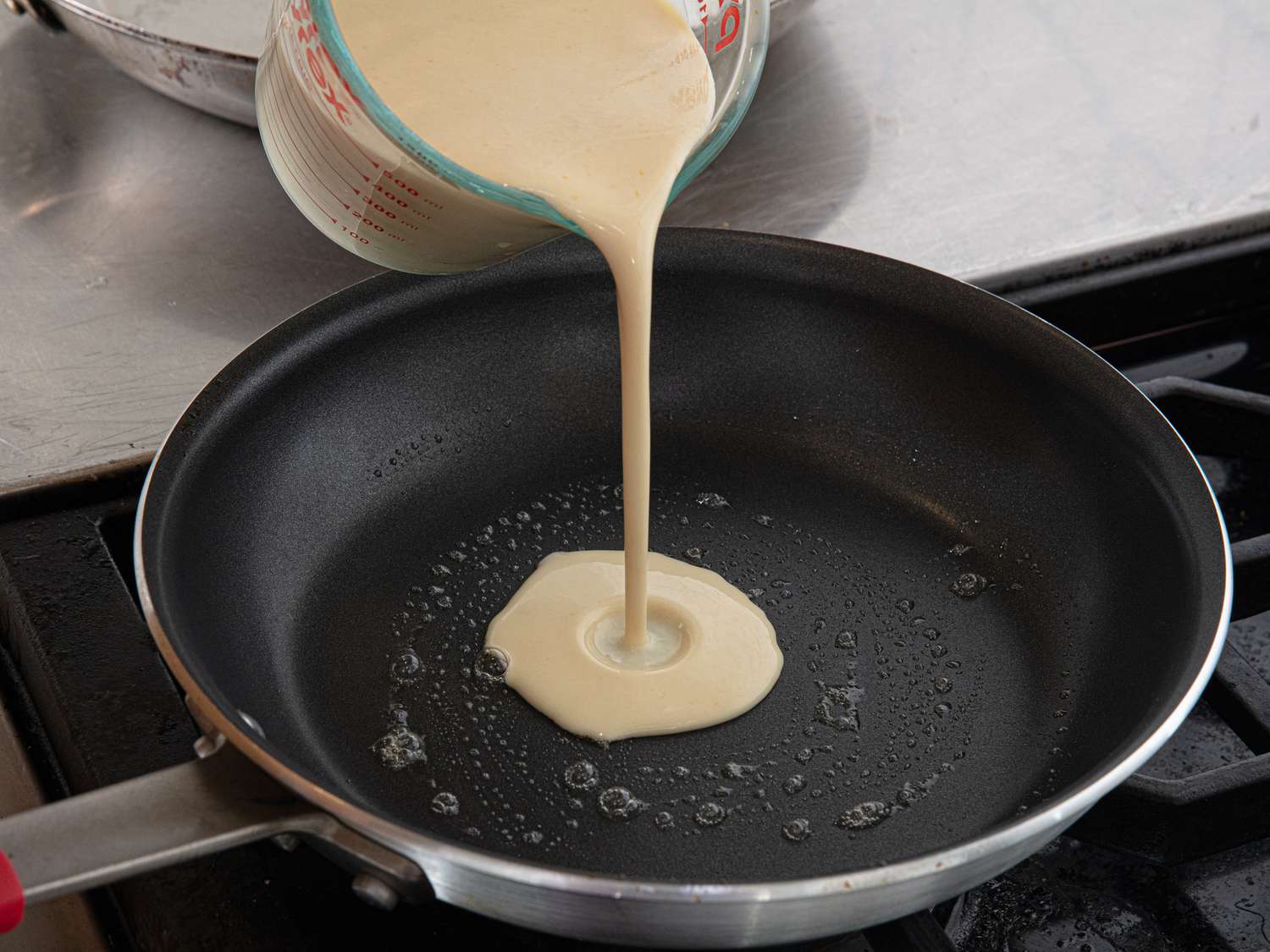 Side view of pouring crepe batter