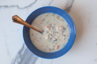 Le Creuset Stoneware Soup Bowl with soup on a counter top