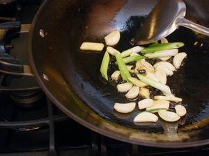 Garlic, Ginger, and Scallions cooking in a wok. 