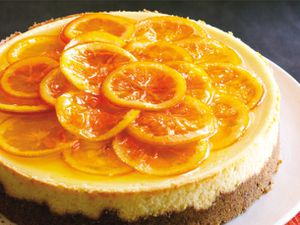 A caramelized orange cheesecake with candied orange slices on top. 