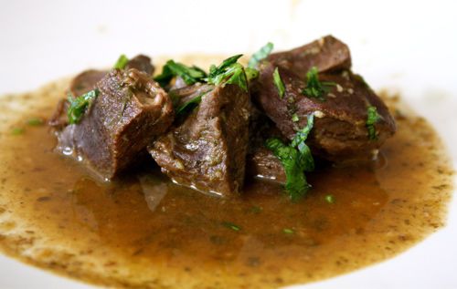 Beef heart stew in a white ceramic bowl.