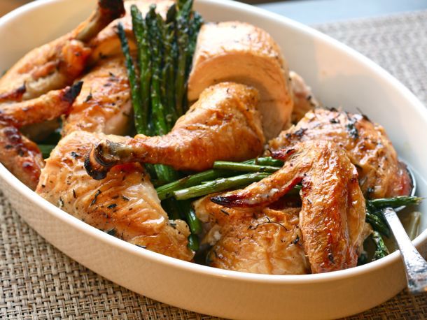 A serving dish of roast chicken with leeks and asparagus