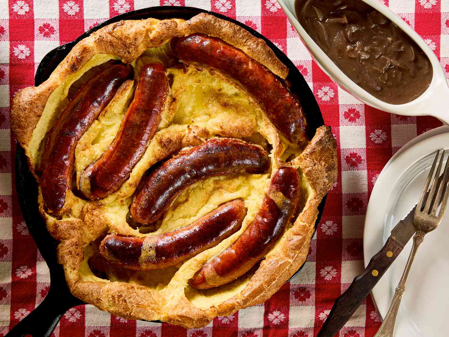 Toad in the Hole served in a skillet with a red checkered tablecloth