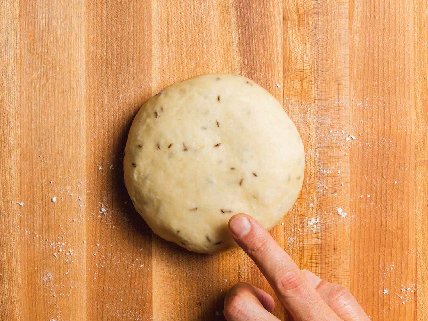 Rested samosa pastry dough on a work surface.