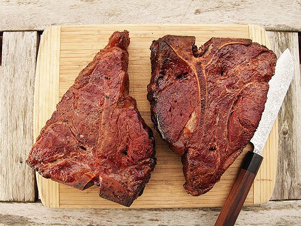 The smoked porterhouses, resting on a cutting board.