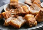 A close up of lechon kawali (Filipino crispy pork belly) on a plate.