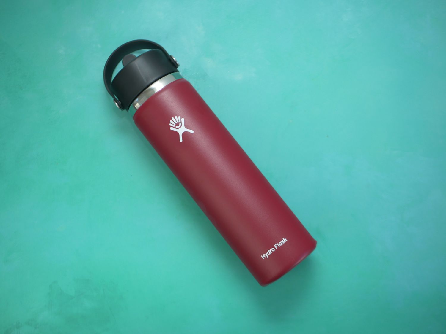 hydro flask water bottle on blue green backdrop