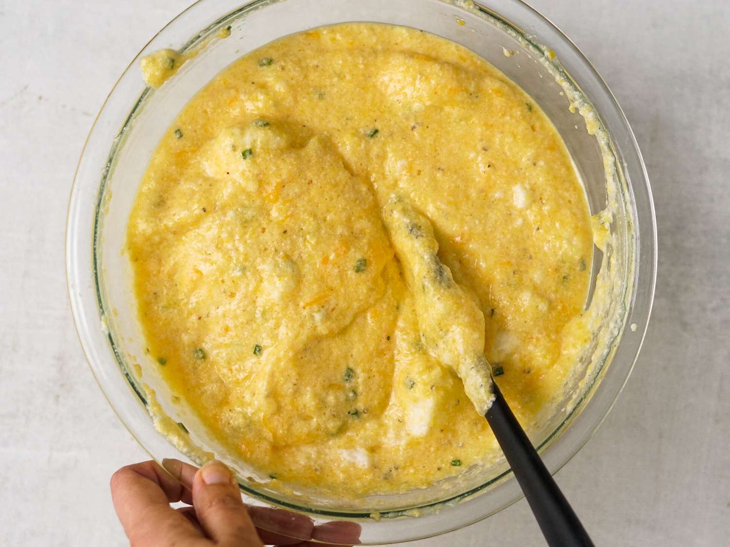 The bowl of grits with the egg whites fully folded in.