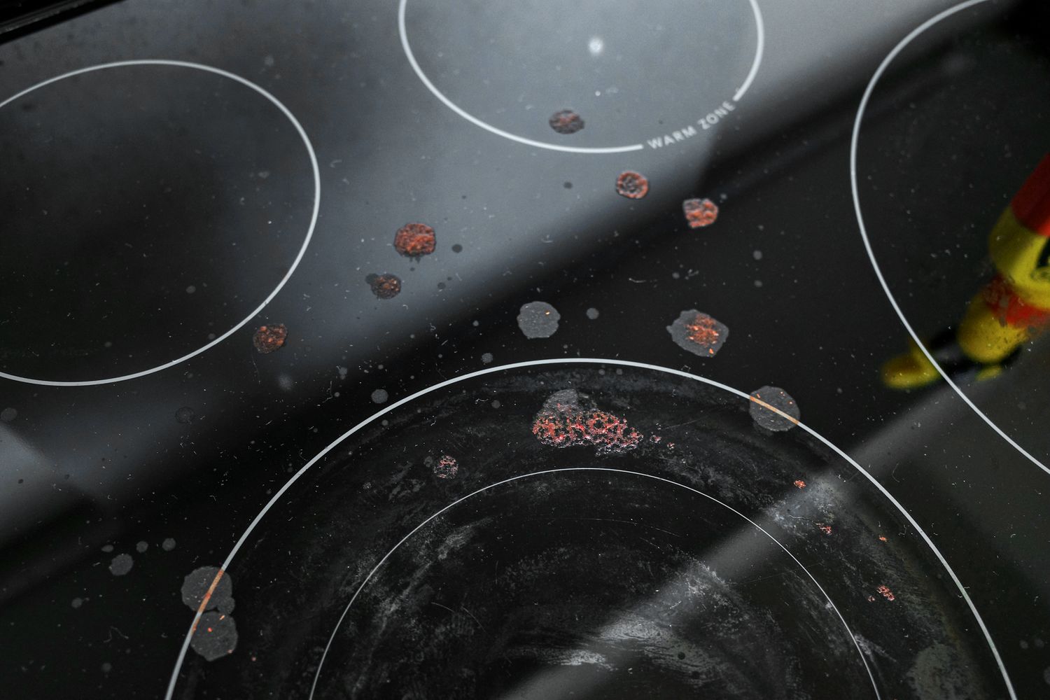 Tomato sauce splattered on a glass stovetop