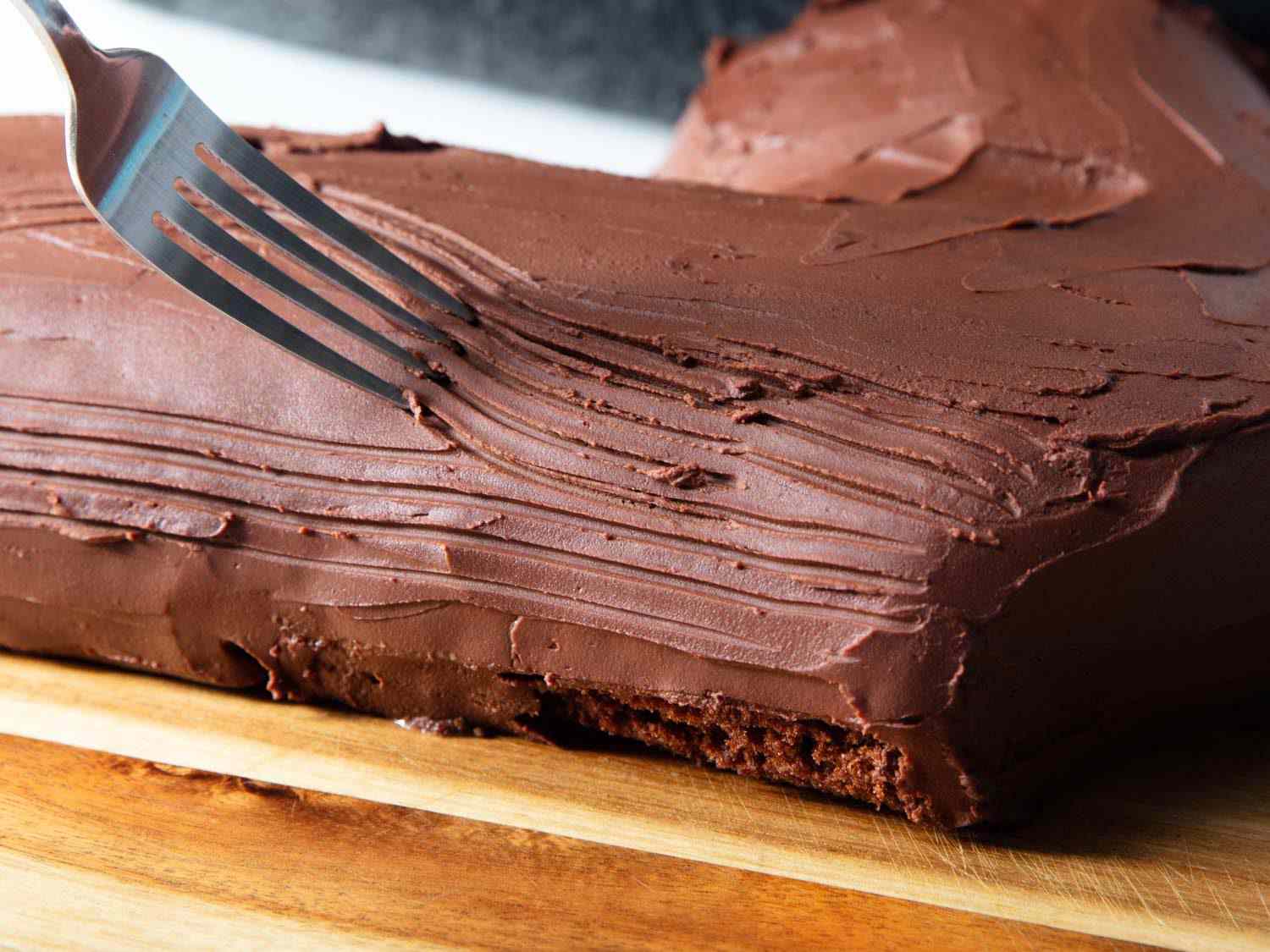 Texturizing the ganache with a fork to create a bark-like surface.