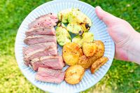 A plate of sliced Butcherbox steak grilled zucchini and roasted potatoes