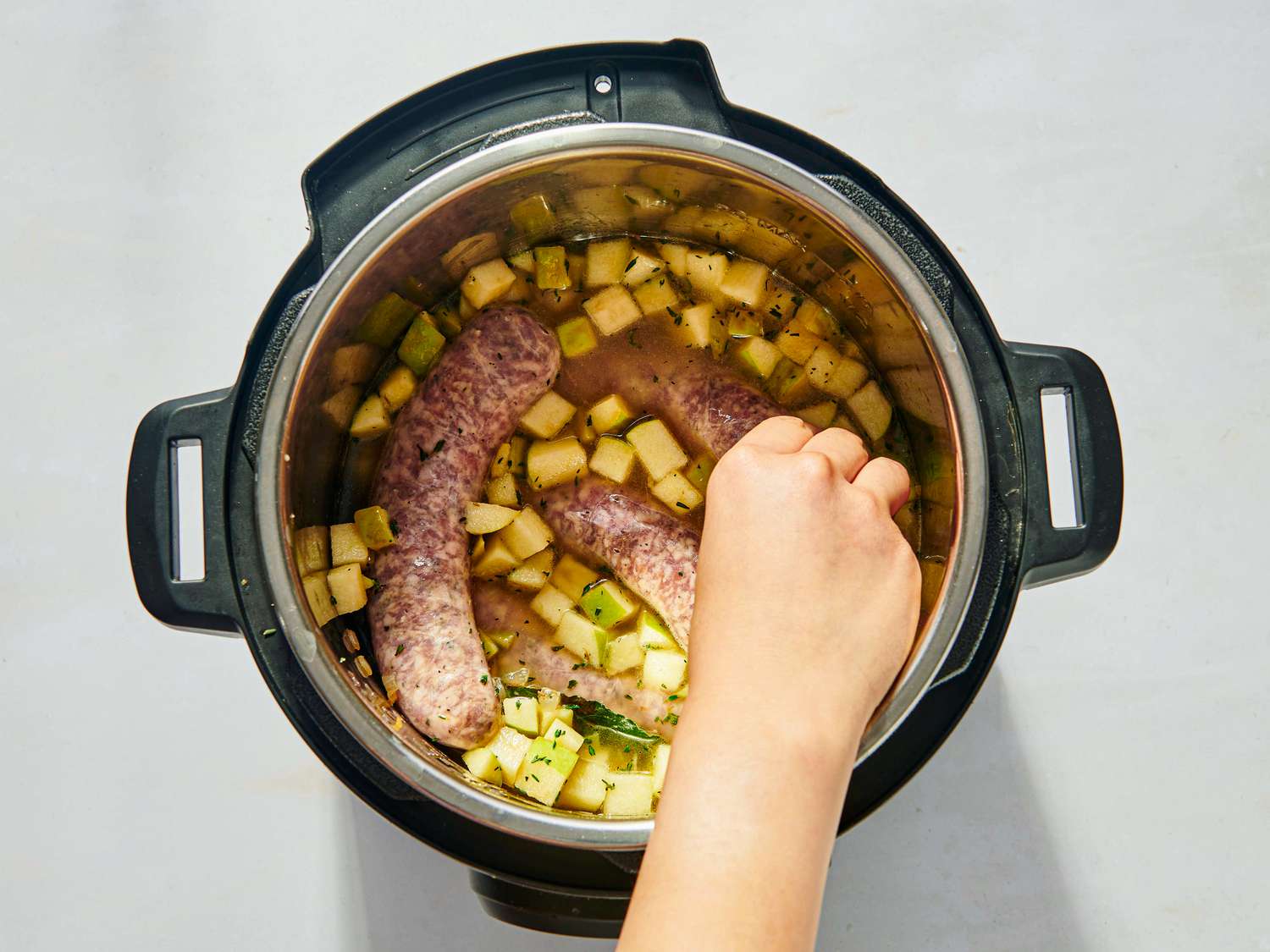 Nestling sausage into sauted lentils 