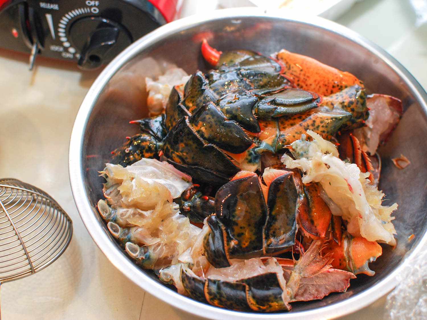 Pieces of raw lobster ready for simmering in a Chinese hot pot.