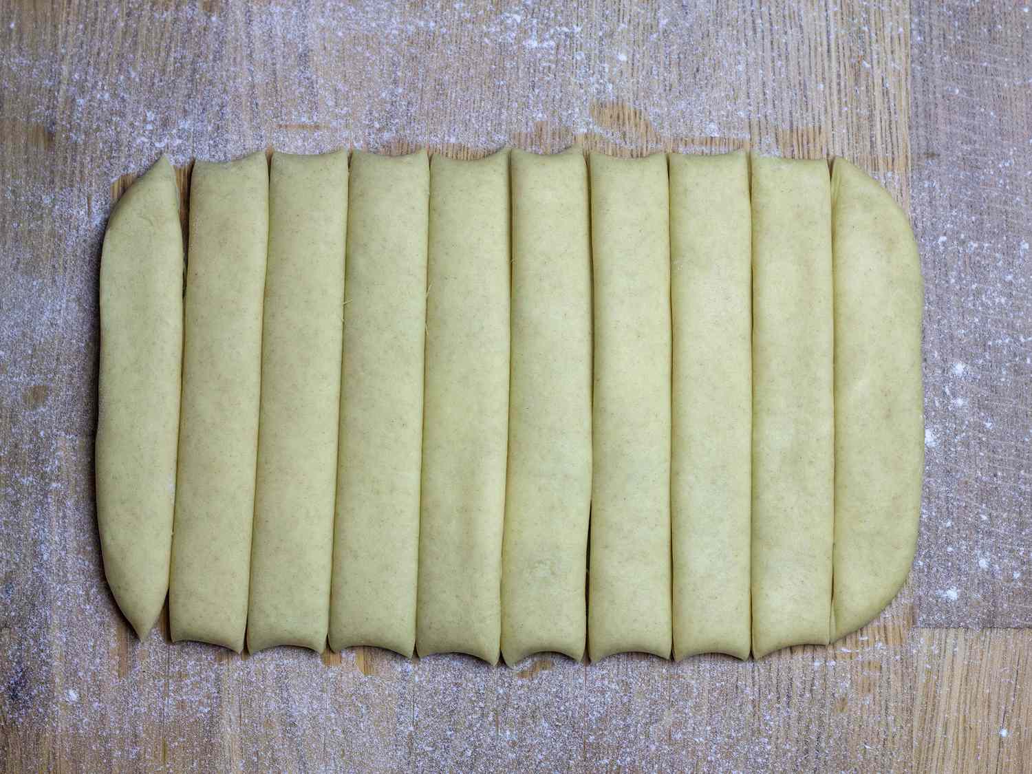 Rested youtiao dough cut into 10 equal strips