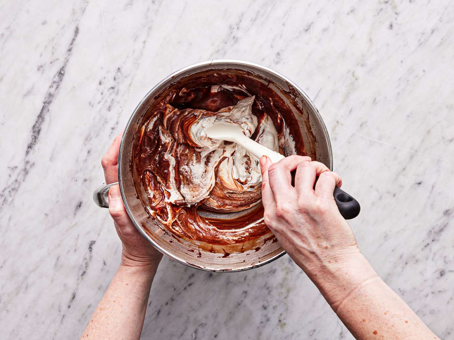 Folding more whipped cream into chocolate mixture
