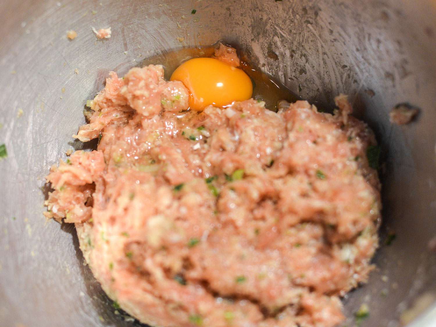 Egg is then added to the tsukune mixture.