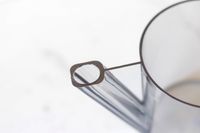 Closeup of a transparent plastic cup with a handle