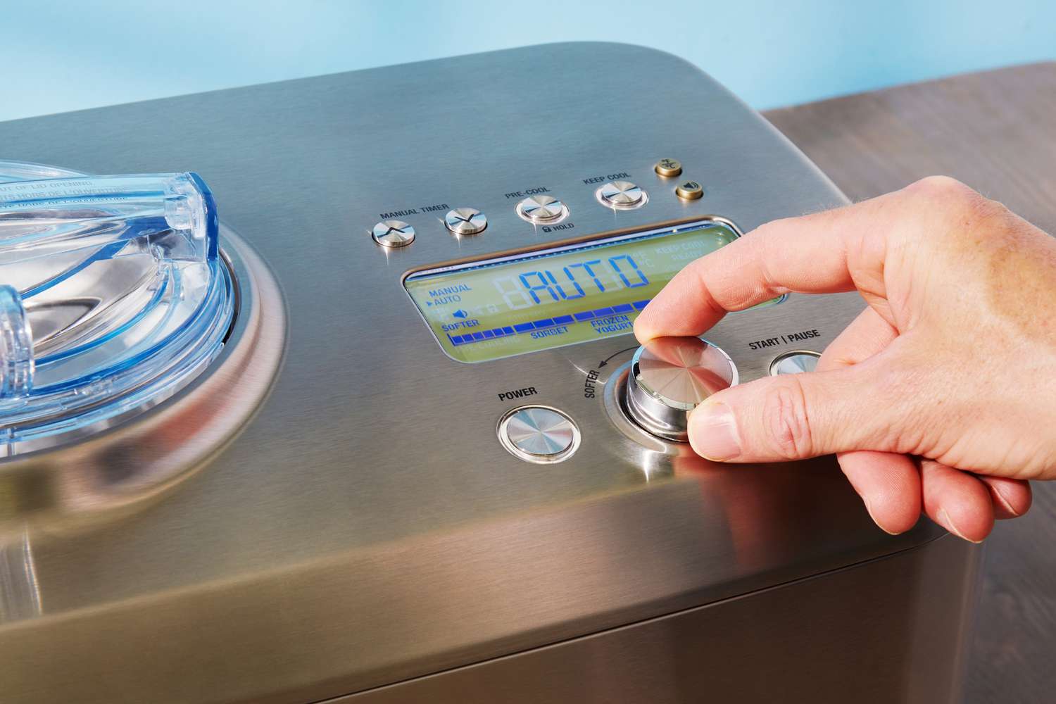 Hand adjusting control dial on Breville The Smart Scoop Ice Cream Maker