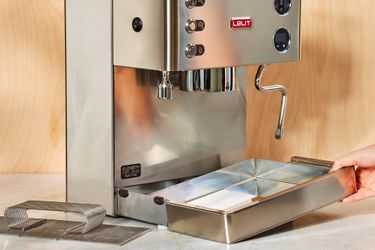 A person lifting up the tray of the Lelit Elizabeth Espresso Machine