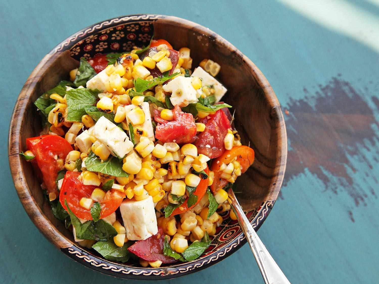 A bowl of Grilled Corn, Tomato, Feta, and Herb Salad.