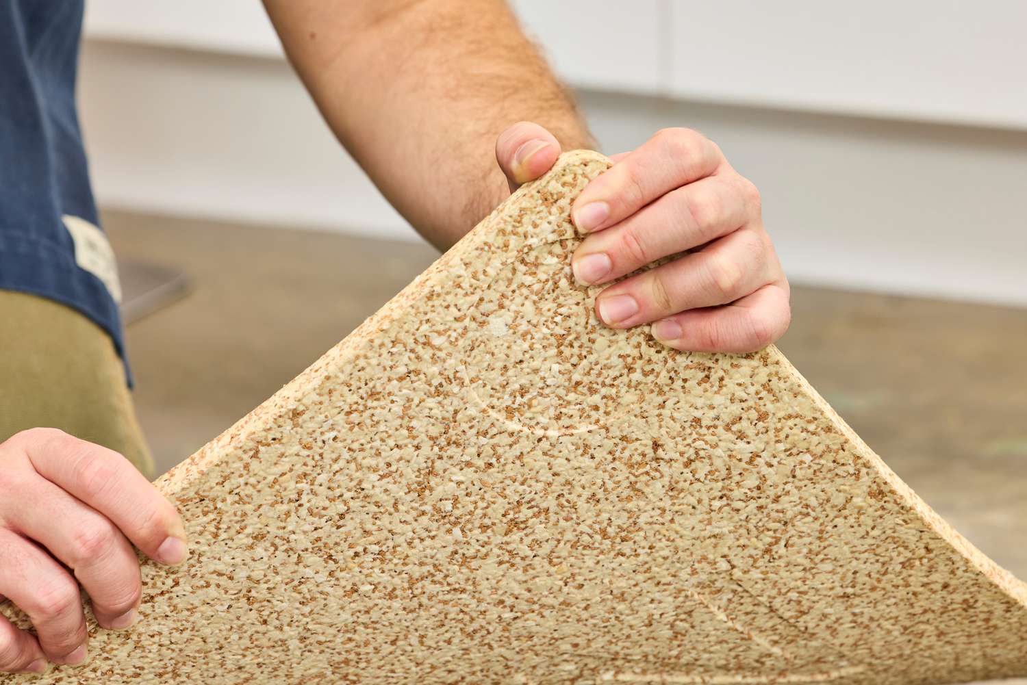 A person lifts the Fulton Standing Mat